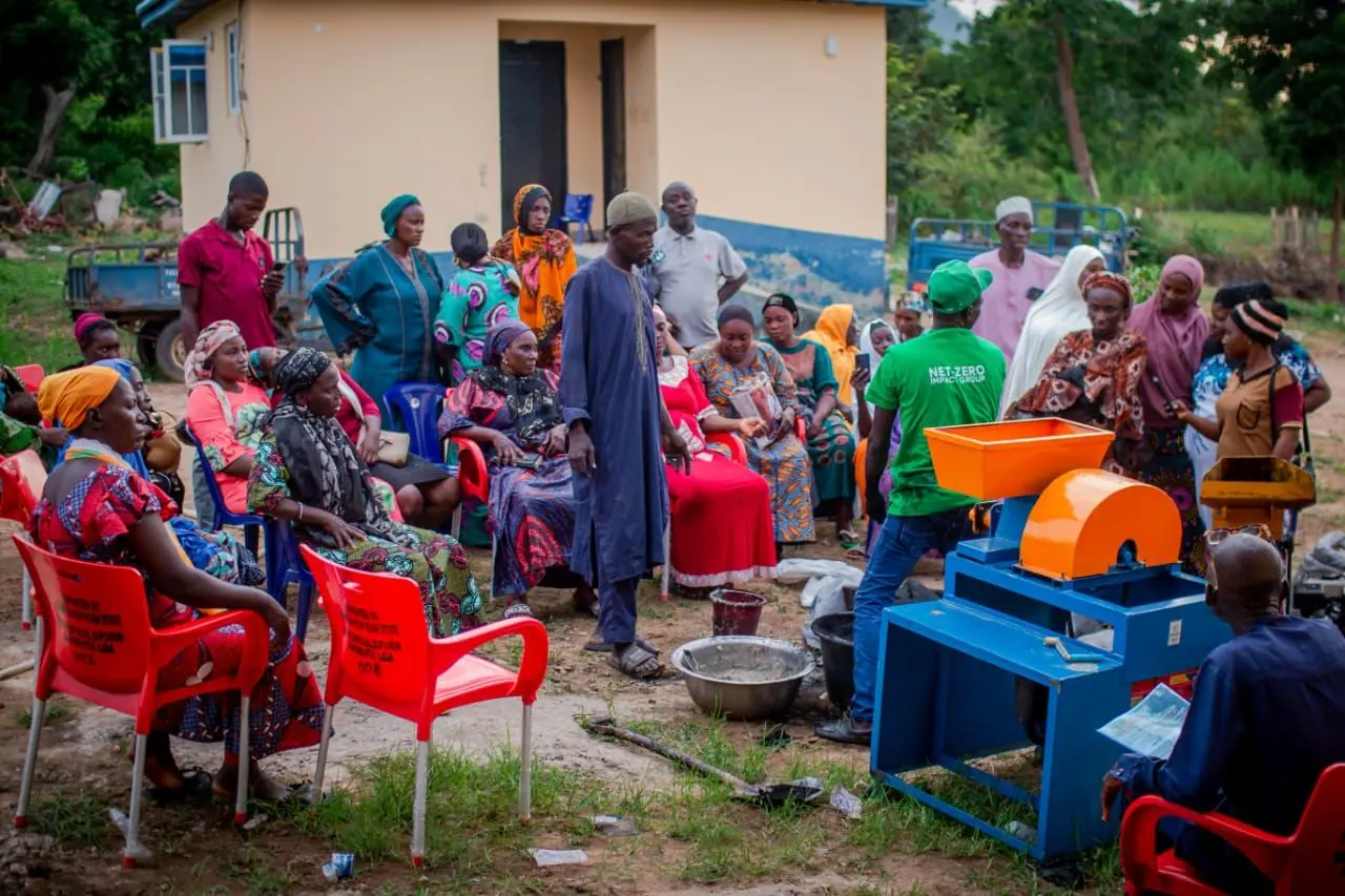 Community members learning briquette production techniques